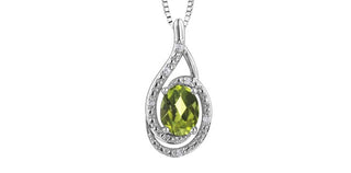 Teardrop-shaped pendant with green gemstone and diamond accents on a white background