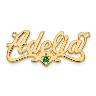 Gold pendant with 'Adelicia' and a green gemstone on a white background