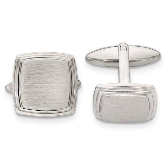 Pair of silver cufflinks on a white background