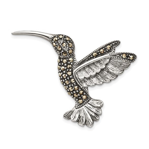 Silver hummingbird-shaped earring with marcasite stones on a white background