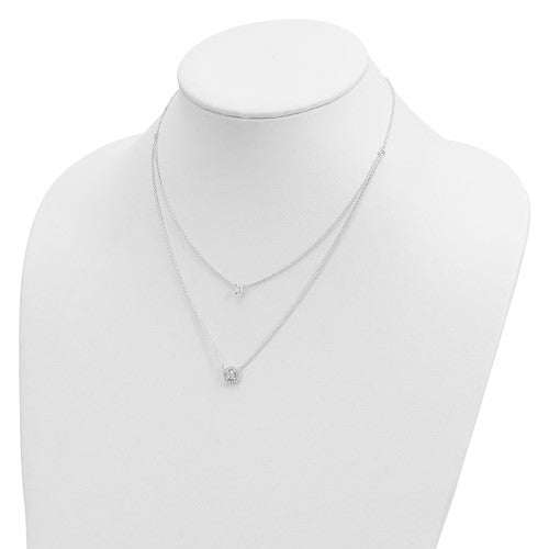 Silver necklace on a mannequin bust against a white background