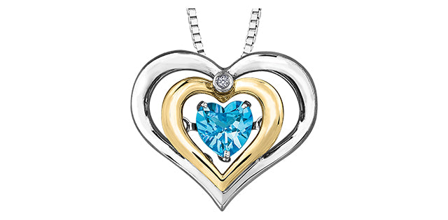 Heart-shaped pendant with blue gemstone and gold and silver accents on a white background