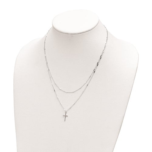 Silver necklace with a cross pendant on a mannequin bust against a white background