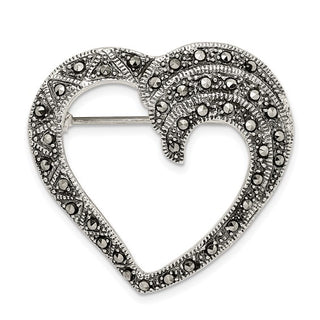 Heart-shaped brooch with decorative elements on a white background