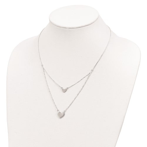Silver heart-shaped necklace on a mannequin with a white background