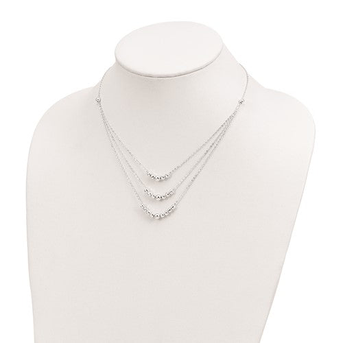 Silver necklace on a mannequin bust against a white background