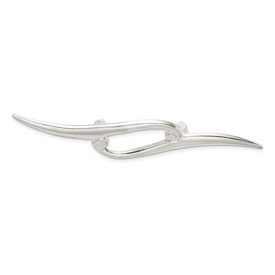 Silver brooch with a curved design on a white background