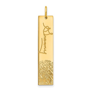 Gold pendant with engraved design on a white background