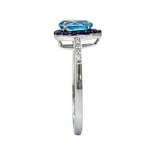 10K White Gold 7x5mm Pear Cut Sky Blue Topaz with Blue Sapphire Halo and 0.10cttw Diamond Ring